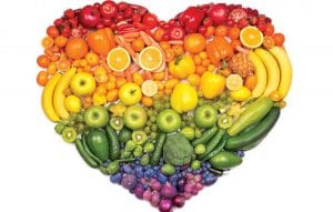 Heart shape made of colorful fruits and vegetables arranged by color