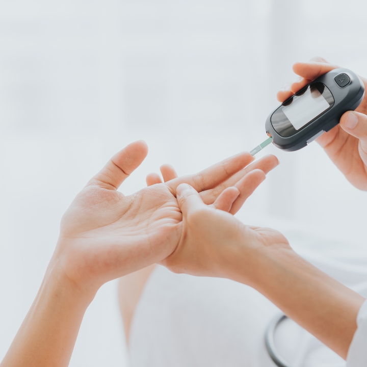 Person using a blood glucose meter to check blood sugar levels