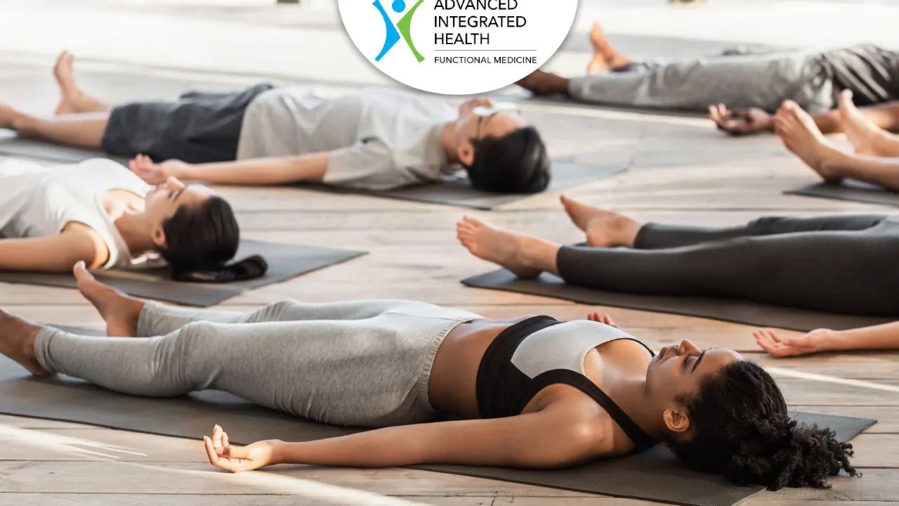 People resting in Savasana, a calming Pitta-pacifying yoga pose