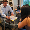 Dr. Robert White talking with a female patient in his chamber.