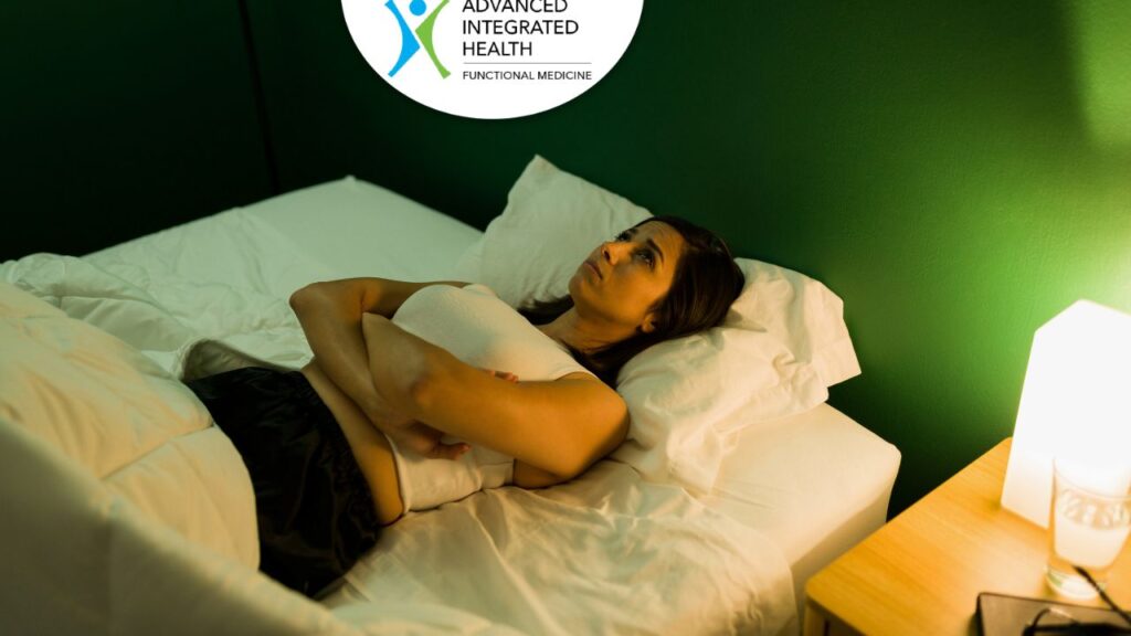 Woman awake at night with insomnia seeking natural sleep solutions at Advanced Integrated Health